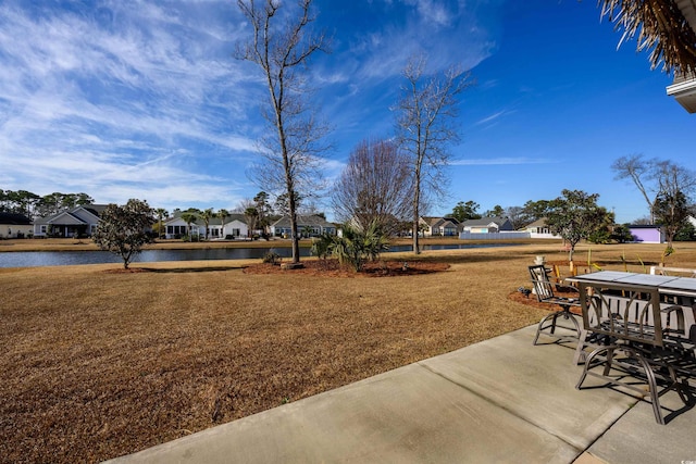 view of yard with a water view and a patio