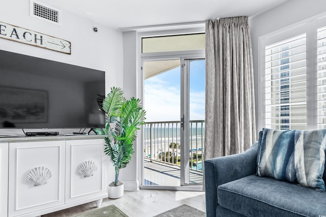 living room featuring hardwood / wood-style flooring and a water view