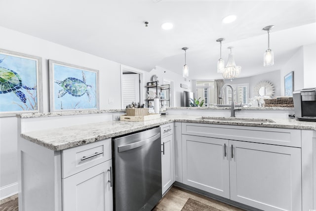 kitchen with dishwasher, dark hardwood / wood-style flooring, light stone counters, and sink