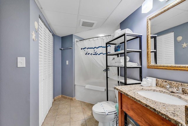 bathroom with vanity, toilet, curtained shower, and tile patterned flooring