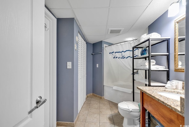 full bathroom featuring tile patterned floors, toilet, vanity, shower / bath combo, and a drop ceiling