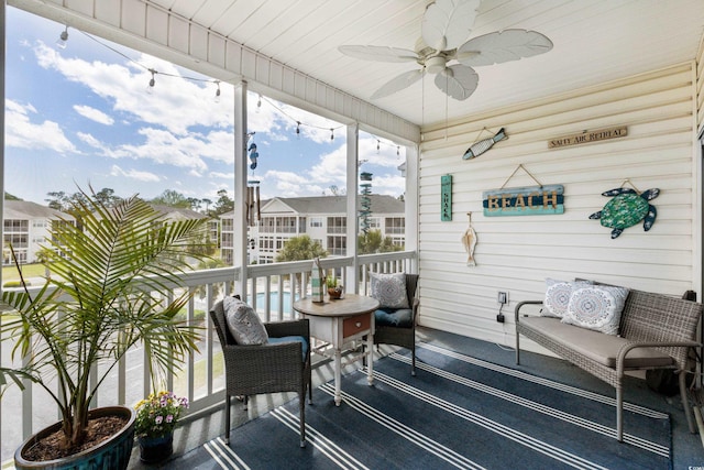 sunroom / solarium featuring ceiling fan