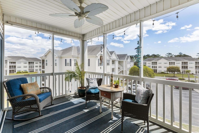 sunroom featuring ceiling fan