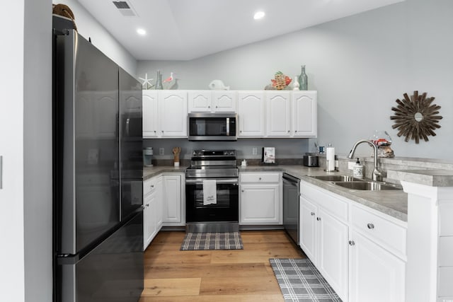 kitchen featuring kitchen peninsula, sink, white cabinets, and appliances with stainless steel finishes