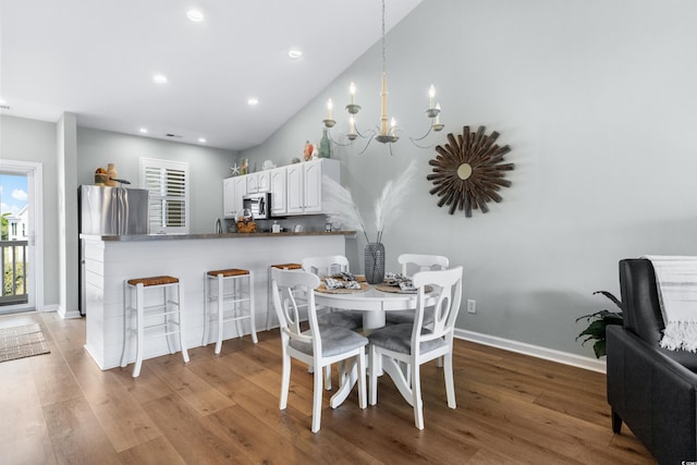 dining room featuring light wood-type flooring and a chandelier