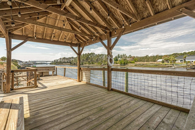 view of dock with a deck with water view and a gazebo