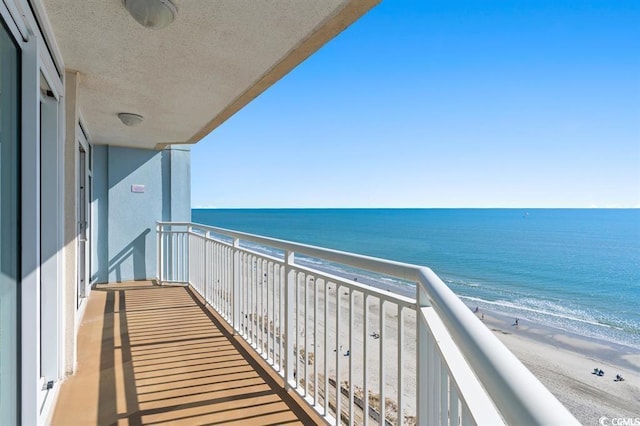 balcony with view of water and beach