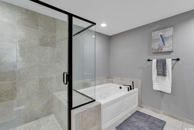 bathroom with tile patterned floors and independent shower and bath