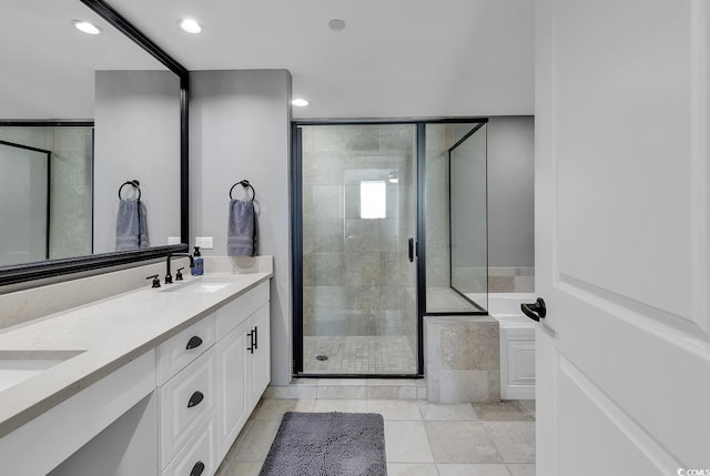 bathroom featuring tile patterned flooring, vanity, and independent shower and bath