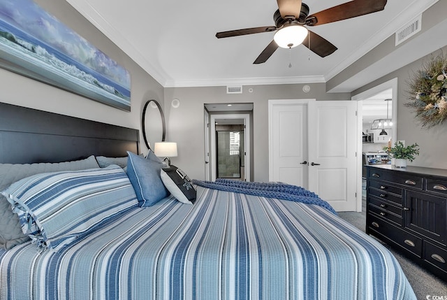 carpeted bedroom featuring ceiling fan and crown molding