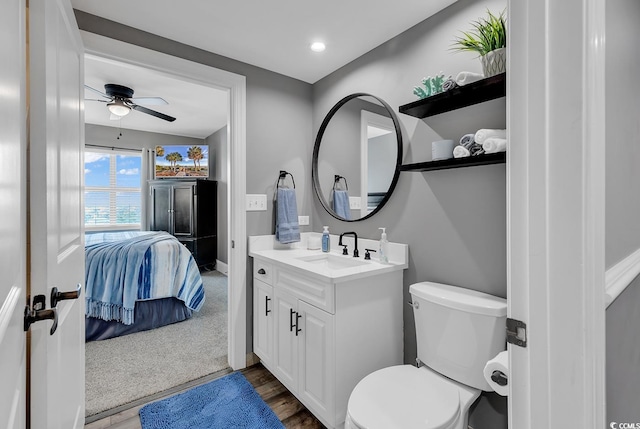 bathroom with vanity, toilet, and ceiling fan