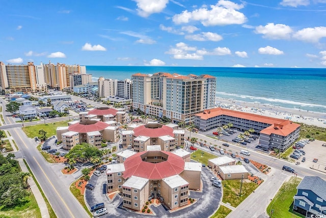 birds eye view of property with a water view and a view of the beach