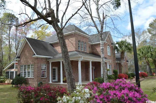 view of front of house featuring a front yard and covered porch