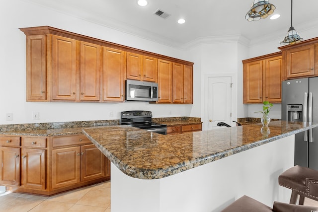 kitchen with a kitchen bar, crown molding, pendant lighting, and appliances with stainless steel finishes