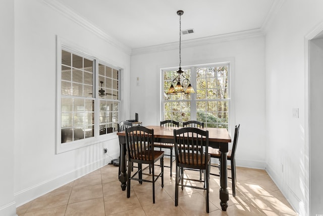 tiled dining space featuring crown molding