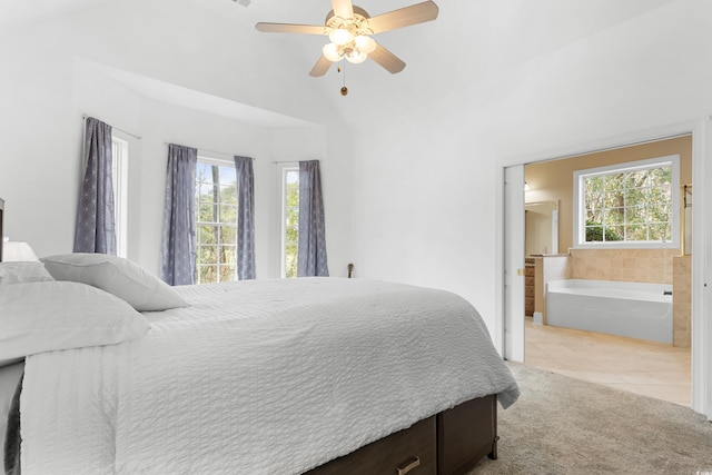 carpeted bedroom featuring connected bathroom, multiple windows, ceiling fan, and lofted ceiling