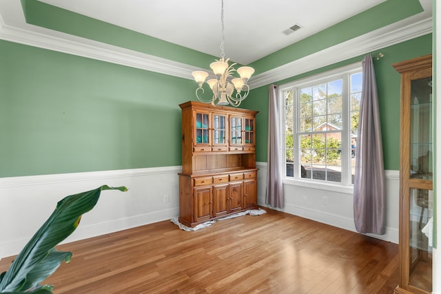 dining space featuring light hardwood / wood-style floors and a notable chandelier