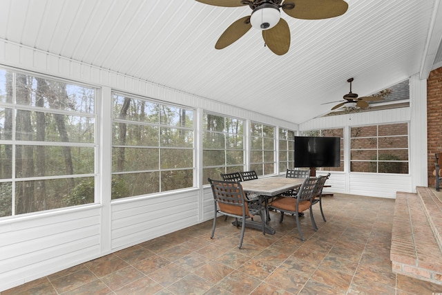 sunroom / solarium with ceiling fan and vaulted ceiling