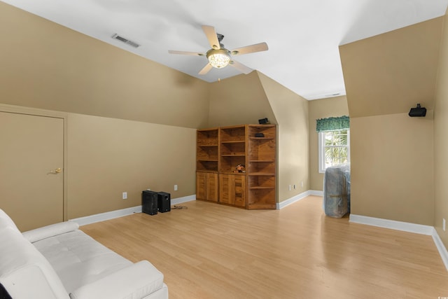 living room featuring light hardwood / wood-style flooring, ceiling fan, and lofted ceiling