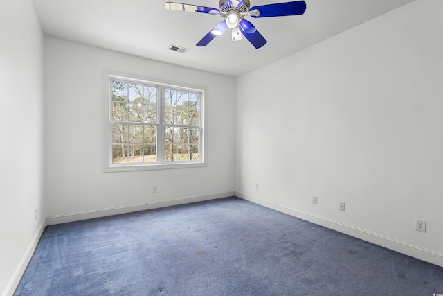 empty room featuring ceiling fan and carpet