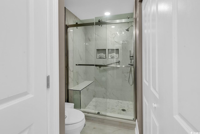 bathroom with an enclosed shower and toilet