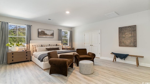 bedroom featuring light hardwood / wood-style floors and multiple windows