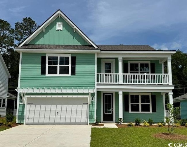 view of front of home with a balcony, board and batten siding, covered porch, an attached garage, and concrete driveway