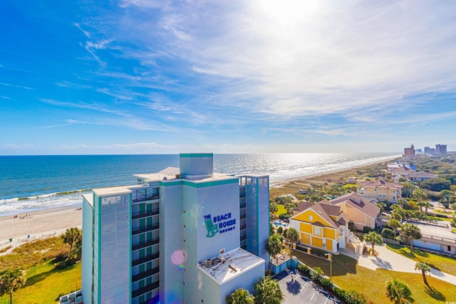 birds eye view of property featuring a water view and a beach view