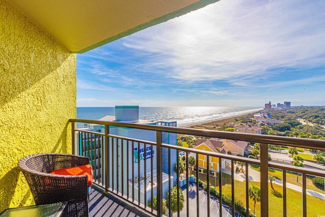 balcony featuring a water view and a view of the beach