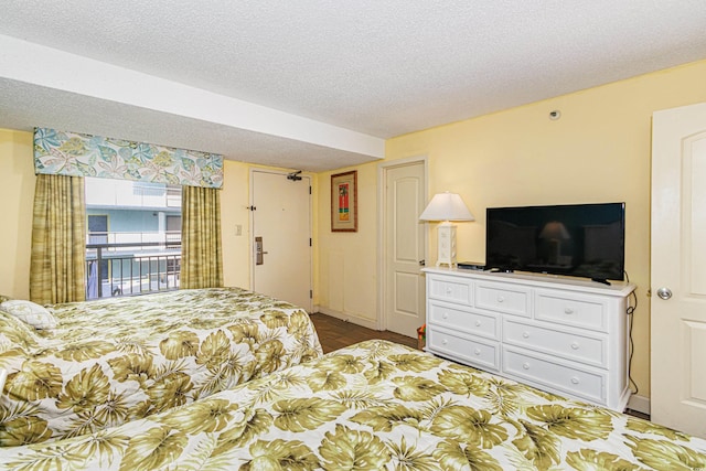 bedroom featuring access to outside and a textured ceiling