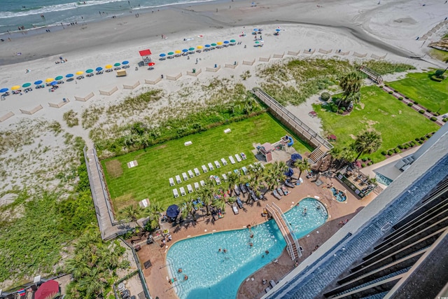 bird's eye view with a water view and a beach view