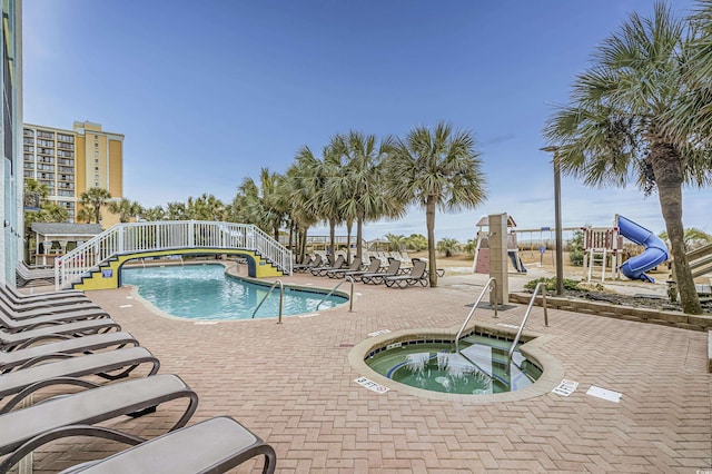 view of swimming pool with a community hot tub and a patio area