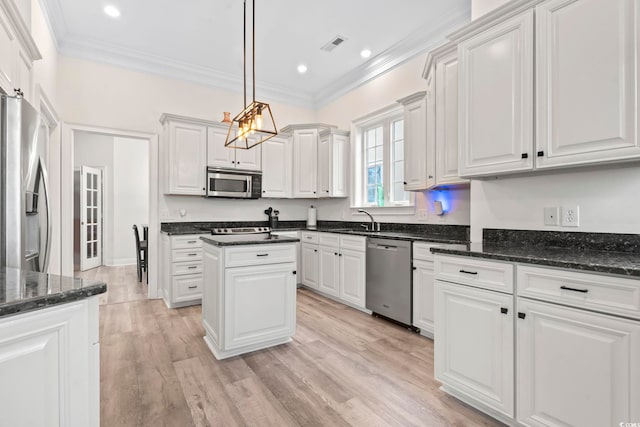 kitchen with pendant lighting, a center island, white cabinetry, and stainless steel appliances