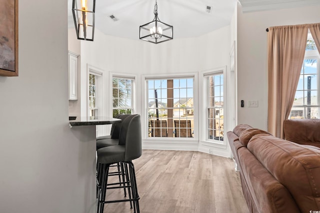 interior space with light hardwood / wood-style flooring and an inviting chandelier