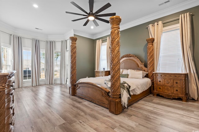 bedroom with light wood-type flooring, ceiling fan, and crown molding