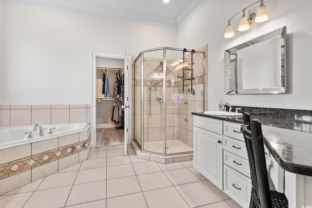 bathroom featuring tile patterned flooring, vanity, shower with separate bathtub, and ornamental molding