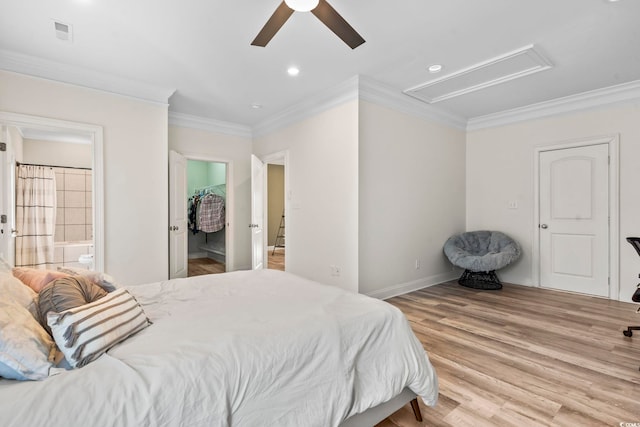 bedroom with light wood-type flooring, connected bathroom, ceiling fan, and crown molding