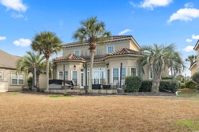 rear view of house featuring a yard