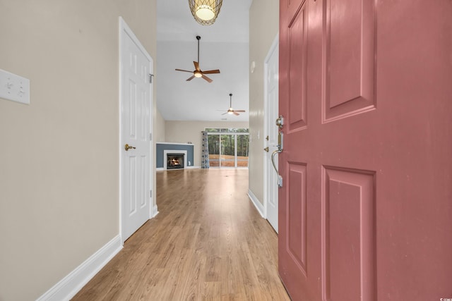 entrance foyer featuring ceiling fan, light hardwood / wood-style floors, and lofted ceiling