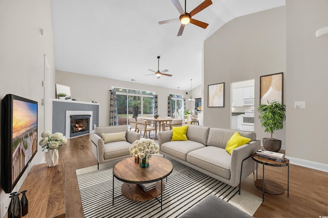 158 Regency Dr, Conway, SC 29526 - living area featuring a ceiling fan, wood finished floors, a warm lit fireplace, and high vaulted ceiling