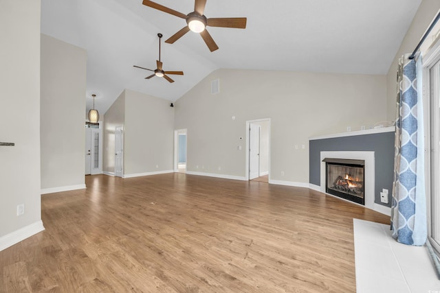 unfurnished living room featuring ceiling fan, light hardwood / wood-style flooring, and high vaulted ceiling