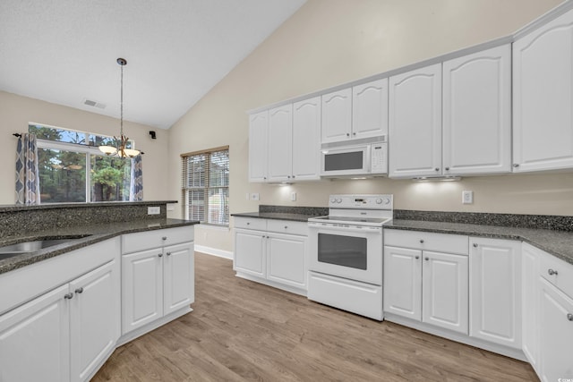 kitchen with white cabinetry, a notable chandelier, light hardwood / wood-style floors, decorative light fixtures, and white appliances