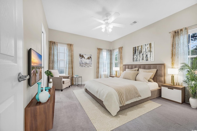 bedroom with ceiling fan and light carpet