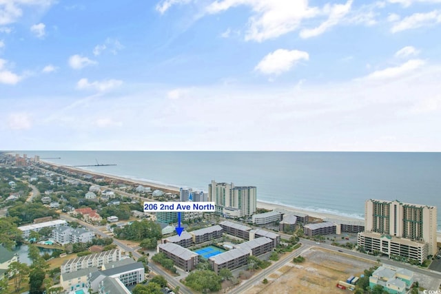 birds eye view of property featuring a view of city and a water view