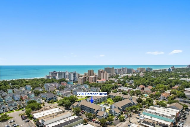 birds eye view of property featuring a water view and a city view