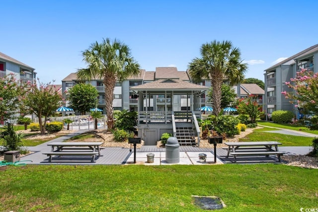 view of home's community with a gazebo, stairs, and a yard