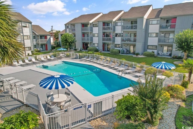 community pool featuring fence and a patio