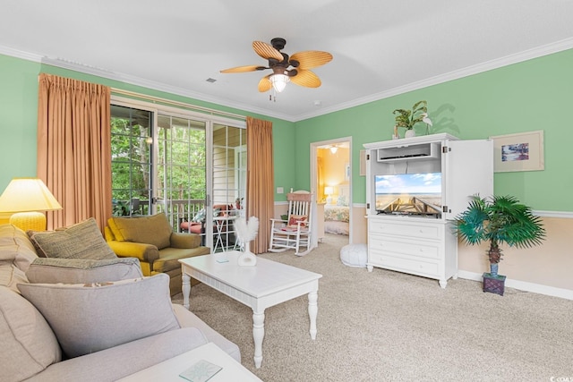 living room featuring ornamental molding, ceiling fan, and carpet