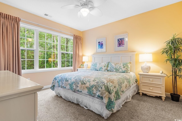 bedroom with ceiling fan and light carpet