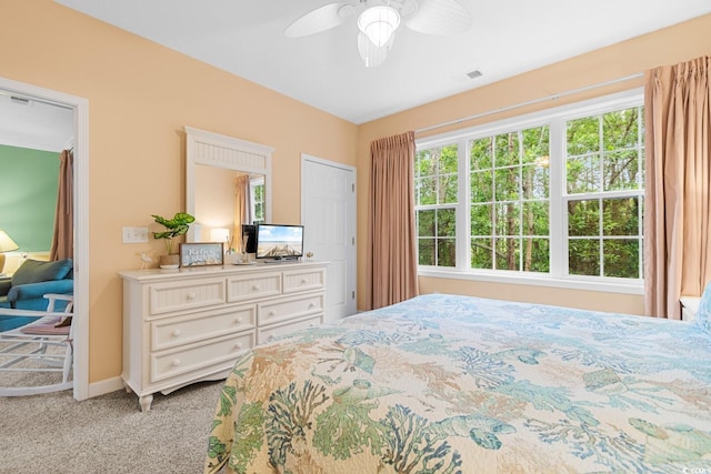 bedroom with ceiling fan and light colored carpet